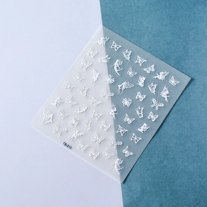 Detail of 5D white embossed nail stickers with 3D butterfly and fairy elf patterns