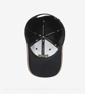 Detail view of the reinforced inner structure and canvas lining of the black baseball cap