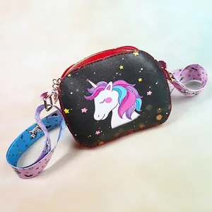 Close-up of black unicorn kid's crossbody bag with wide printed strap and gold hardware