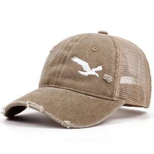 Detail of distressed brown trucker hat with bird embroidery and breathable mesh
