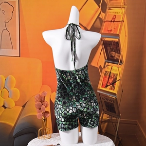 Detailed halter neck jumpsuit featuring bold green and black abstract snakeskin print