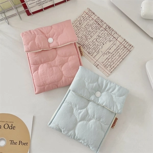 Close-up of pink and blue quilted cotton sanitary storage pouches with button closure