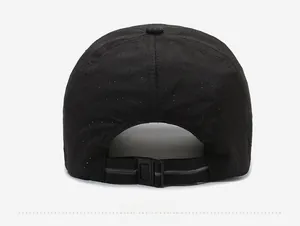 Detail view of the breathable mesh fabric and adjustable buckle on the black baseball cap