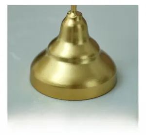Macro shot of the wide matte gold metal candle holder base for stable tabletop placement