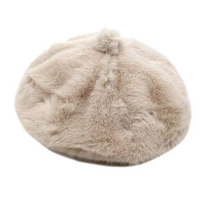 Close-up of beige plush beret featuring soft faux fur texture and top pom-pom detail