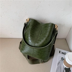 Dark green crocodile pattern bucket bag with a wide fabric strap and gold hardware
