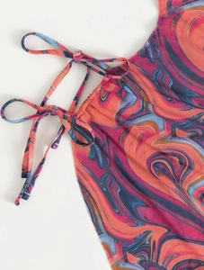 Detail of colorful marble print bikini fabric with adjustable strings and fine stitching