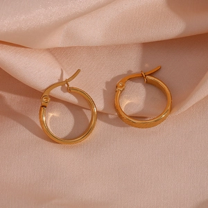 Detail of 20mm gold plated stainless steel hoop earrings with diagonal stripe texture