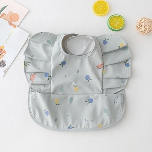 Detail of waterproof baby bib with cute fruit pattern and frilled sleeve design
