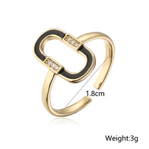 Detail view of 18K gold plated ring with black enamel, zircon inlay, and 1.8cm inner diameter
