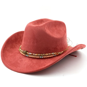 Detail of red suede cowboy hat featuring ethnic colorful beaded band and western stone accent