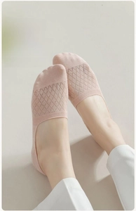 Detail of light pink mesh invisible socks with breathable diamond knit on a light background