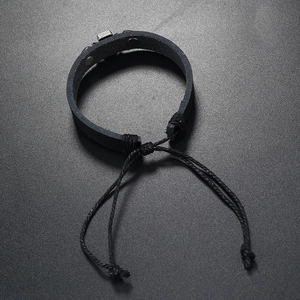 Detail of adjustable braided leather cross bracelet with black woven cotton cord