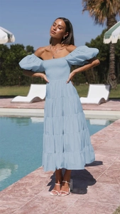 Detail of the light blue off-shoulder smocked bodice and puff sleeves on a summer dress