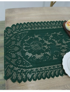Detailed top view of a dark green lace table runner featuring intricate woven patterns