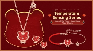 Three-piece jewelry set with red tiger motifs in rose gold finish for New Year