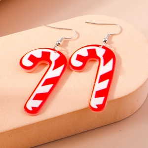 Macro shot of red and white striped candy cane earrings made of acrylic material