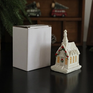 Illuminated resin Christmas snowy church model ornament with warm LED glowing windows