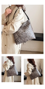 Detailed close-up of a large leopard print shoulder bag with black strap and spacious design