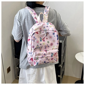 Dettaglio dello zaino rosa con fantasie floreali e farfalle in nylon resistente