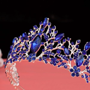 Close-up of luxury silver bridal crown with deep blue crystals and rhinestones