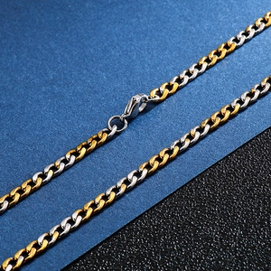 Detail of two-tone gold and silver stainless steel curb chain with secure lobster clasp
