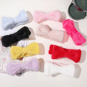 Detailed top view of soft coral fleece bow headbands in nine vibrant colors for face washing