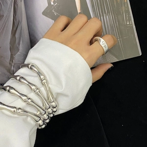 Close-up of a silver skeleton bone bracelet and numbered engraving ring set