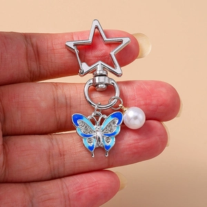 Handheld silver keychain with blue enamel butterfly, faux pearl and rhinestone star charm