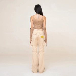Slim fit beige cargo flare pants and brown knit top with sleeves, rear view studio shot