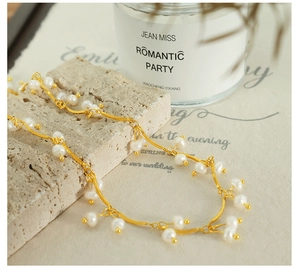 Detail of delicate freshwater pearl tassel necklace on stone with elegant background