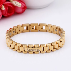 Detail of gold watchband link bracelet featuring magnetic health stones and clasp engraving