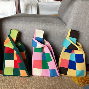 Close-up of vibrant knitted checkerboard tote bags in diverse colorblock combinations