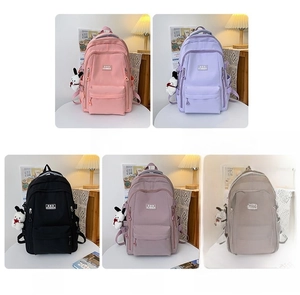 Collage of multi-pocket nylon backpacks in pink, purple, black and blue with doll charms