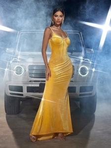 Elegant yellow velvet evening dress with sequins and spaghetti straps on female model