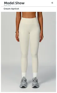Close-up of creamy apricot high-waisted yoga pants with seamless hip-lifting design