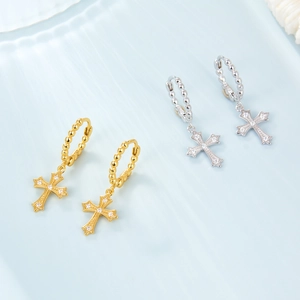 Detail of S925 sterling silver cross earrings with zircon pavé in gold and silver