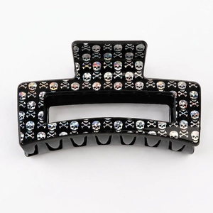 Holographic skull pattern on a black rectangular hair claw clip for Halloween