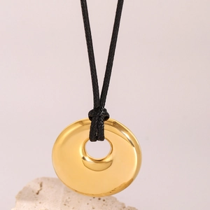 Minimalist 18k gold stainless steel round pendant on adjustable black wax cord
