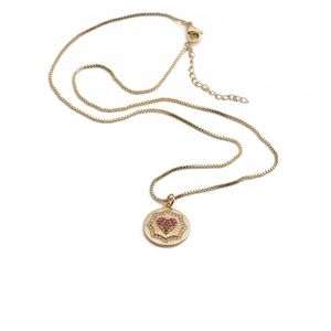 Gold-plated round medallion necklace with red crystal heart and clear stone halo
