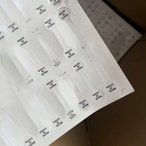 Close-up of white adhesive jewelry labels with Made in China print for rings and tags