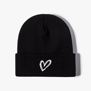 Unisex black knit beanie with white embroidered heart detail for winter warmth