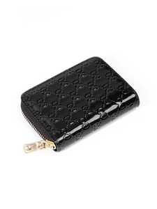 Detail of black patent leather card holder with embossed pattern and zipper closure