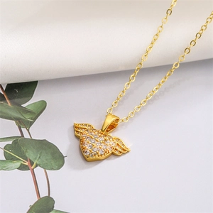 Detail of gold heart pendant necklace with micro-pave crystals and wing design