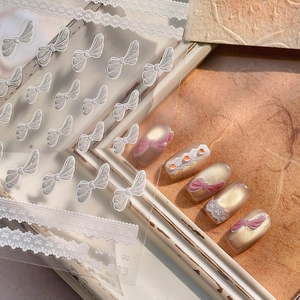 Elegant white lace and glittery bow 3D nail art stickers with pearl finish on model