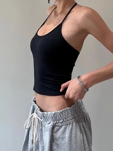 Women's backless black tank top and grey joggers set with a sporty minimalist design