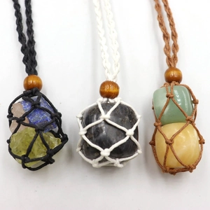 Detailed close-up of handmade woven mesh necklaces in black white and brown colors