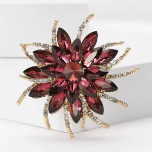 Macro detail of retro flower brooch with burgundy gems and shimmering white crystals