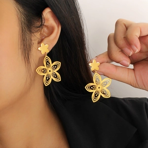 Elegant 18k gold stainless steel earrings with transparent floral petal design on model