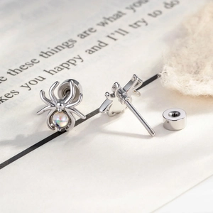 Silver spider stud earrings with iridescent gemstones and screw back design for cartilage